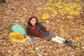 kid with notebook. fall season fashion. teen girl in school uniform hold autumn leaves. Royalty Free Stock Photo