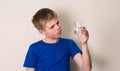 Kid observing a half full or half empty glass of water. Royalty Free Stock Photo