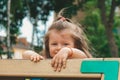 Kid on obstacle course. Pretty happy young girl playing outside in playground. Portrait Of Cute Girl Playing At Royalty Free Stock Photo