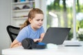 Kid on online lesson in home school. Child learning knowledge through homeschooling and online classes. Young student focused on Royalty Free Stock Photo