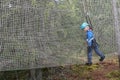 Kid overcoming mesh obstacle in rope adventure park Royalty Free Stock Photo