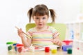 Kid painting with paintbrush Royalty Free Stock Photo