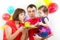 Kid with parents celebrating birthday