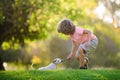 Kid with pets dog. Cute child and puppy playing outside.