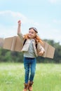 kid in pilot costume with outstretched arm jumping Royalty Free Stock Photo