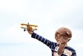 Kid pilot enjoy playig with toy airplane. Freedom concept