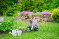 Kid planting flowers in the garden