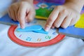Kid play telling time game, young children to learn how to read an analog clock Royalty Free Stock Photo