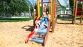 Kid on playground. little girl play outdoor on school yard slide. Healthy activity. Child playing in sunny park. Kid having fun on Royalty Free Stock Photo