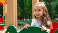 Kid on playground. little girl play outdoor on school yard slide. Healthy activity. Child playing in sunny park. Kid having fun on Royalty Free Stock Photo