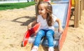 Kid on playground. little girl play outdoor on school yard slide. Healthy activity. Child playing in sunny park. Kid having fun on Royalty Free Stock Photo