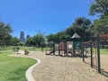 Empty kid playground surrounded by large trees with skyscrapers background in downtown Dallas, Texas, USA Royalty Free Stock Photo