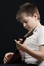 Kid playing balalaika Royalty Free Stock Photo