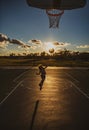 Kid playing basketball. Cute little boy child jumping with basket ball for shot silhouette on sunset. Royalty Free Stock Photo