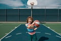 Kid playing basketball. Little caucasian sports child playing basketball holding ball with happy face.