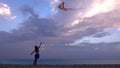 Kid Playing on Beach on Seashore, Child Flying Kite at Sunset on Ocean, Girl on Coastline in Summer Vacation Sea Waves at Sundown Royalty Free Stock Photo