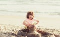 Kid playing on the beach on summer holidays. Child building a sandcastle at sea. Boy play with sand on summer beach. Royalty Free Stock Photo