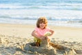 Kid playing on the beach on summer holidays. Child building a sandcastle at sea. Boy play with sand on summer beach. Royalty Free Stock Photo