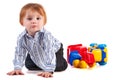 Kid playing with car toy isolated on white