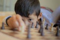 Kid playing chess in his house Royalty Free Stock Photo