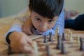 Kid playing chess in his house Royalty Free Stock Photo