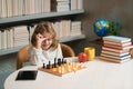 Kid playing chess in the room. Early development. Child thinking about chess. The concept of learning and growing Royalty Free Stock Photo