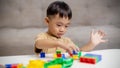 The kid playing with colorful toy blocks. Little boy building the car of block toys. Educational and creative toys and games for Royalty Free Stock Photo