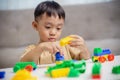 The kid playing with colorful toy blocks. Little boy building the car of block toys. Educational and creative toys and games for Royalty Free Stock Photo