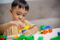 The kid playing with colorful toy blocks. Little boy building the car of block toys. Educational and creative toys and games for Royalty Free Stock Photo