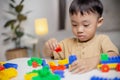 The kid playing with colorful toy blocks. Little boy building the car of block toys. Educational and creative toys and games for Royalty Free Stock Photo