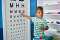Kid playing doctor with oculists sign at medical office.