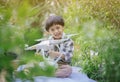 Kid playing drone. Little Pilot Using Drone Remote Controller. Young cute boy holding quadcopter at home. Child playing with drone