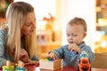 Kid playing logical toys with educator or mother in the classroom in nursery or preschool Royalty Free Stock Photo