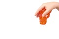 kid playing orange slime with hand, transparent toy Royalty Free Stock Photo