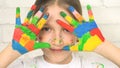 Kid Playing Painted Hands, Child Looking in Camera, Smiling School Girl Face, Homeschooling Project, Children Education Royalty Free Stock Photo
