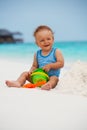 Kid playing with sand on the beach Royalty Free Stock Photo