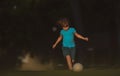 Kid playing soccer, happy child enjoying sports football game, kids activities, little soccer player. Child playing Royalty Free Stock Photo