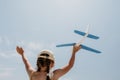 Kid playing with toy airplane. Children dream of travel by plane. Happy child girl has fun in summer vacation by sea and Royalty Free Stock Photo