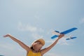 Kid playing with toy airplane. Children dream of travel by plane. Happy child girl has fun in summer vacation by sea and Royalty Free Stock Photo