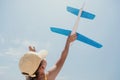 Kid playing with toy airplane. Children dream of travel by plane. Happy child girl has fun in summer vacation by sea and Royalty Free Stock Photo