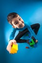 Kid playing toy blocks isolated on the blue background Royalty Free Stock Photo