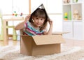 Kid playing in a toy house in children room Royalty Free Stock Photo