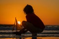 Kid playing with toy sailing boat, toy ship. Travel and adventure concept. Child feeling adventurous while cruising. Kid Royalty Free Stock Photo