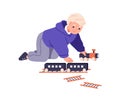 Kid playing with toy train. Toddler boy, railway game. Happy kindergarten preschool child with railroad on floor Royalty Free Stock Photo