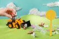 Kid playing with toy truck and collecting trash with scoop Royalty Free Stock Photo