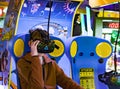 Kid while playing virtual reality game in an arcade game center