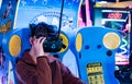 Kid while playing virtual reality game in an arcade game center