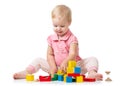 Kid playing with wooden block toys. Baby girl building castle using cubes. Educational toys for preschool and Royalty Free Stock Photo