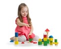 Kid playing with wooden block toys. Baby girl building castle using cubes. Educational toys for preschool and Royalty Free Stock Photo