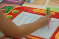 Kid playing write board toy Royalty Free Stock Photo